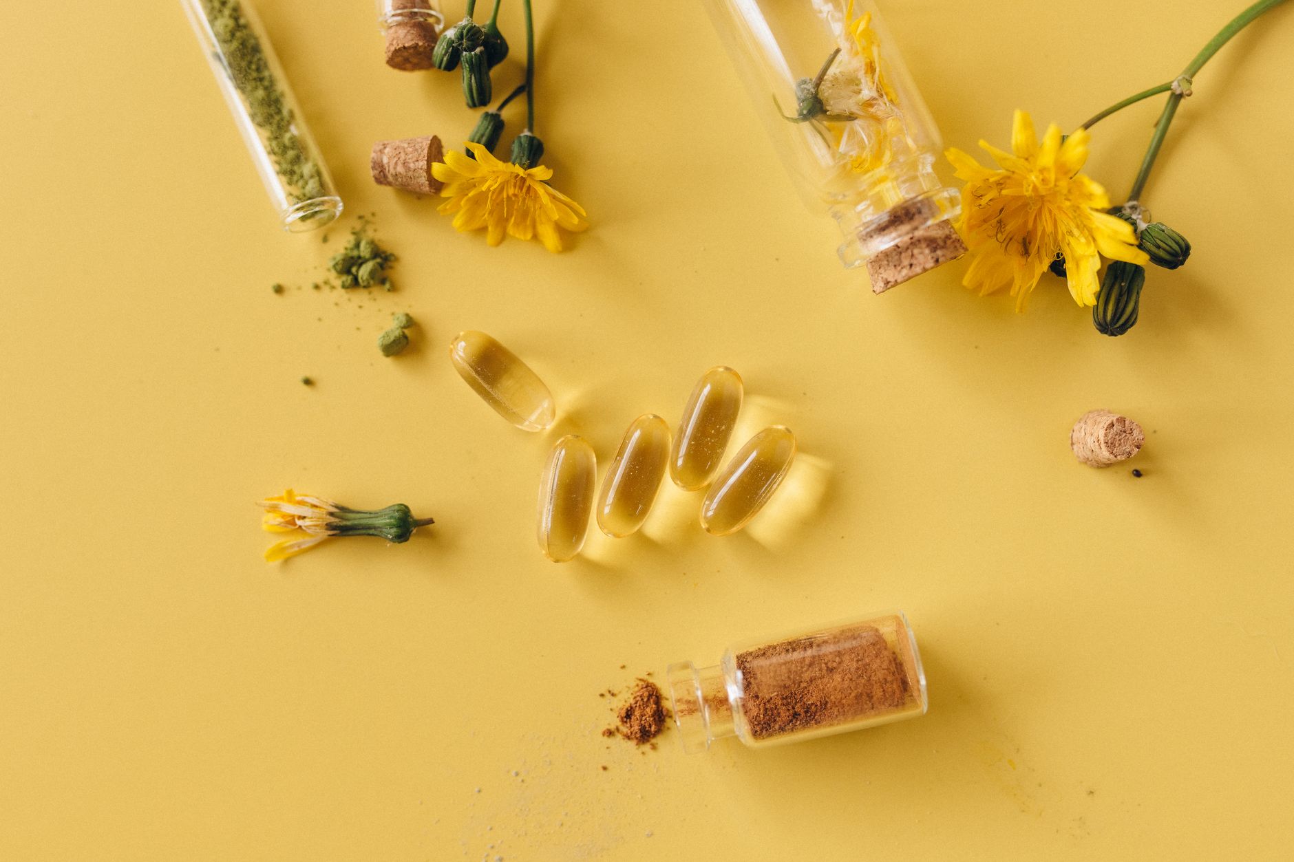 Yellow berberine root powder and capsules on a wooden surface alongside a glucometer, representing metabolic health supplementation