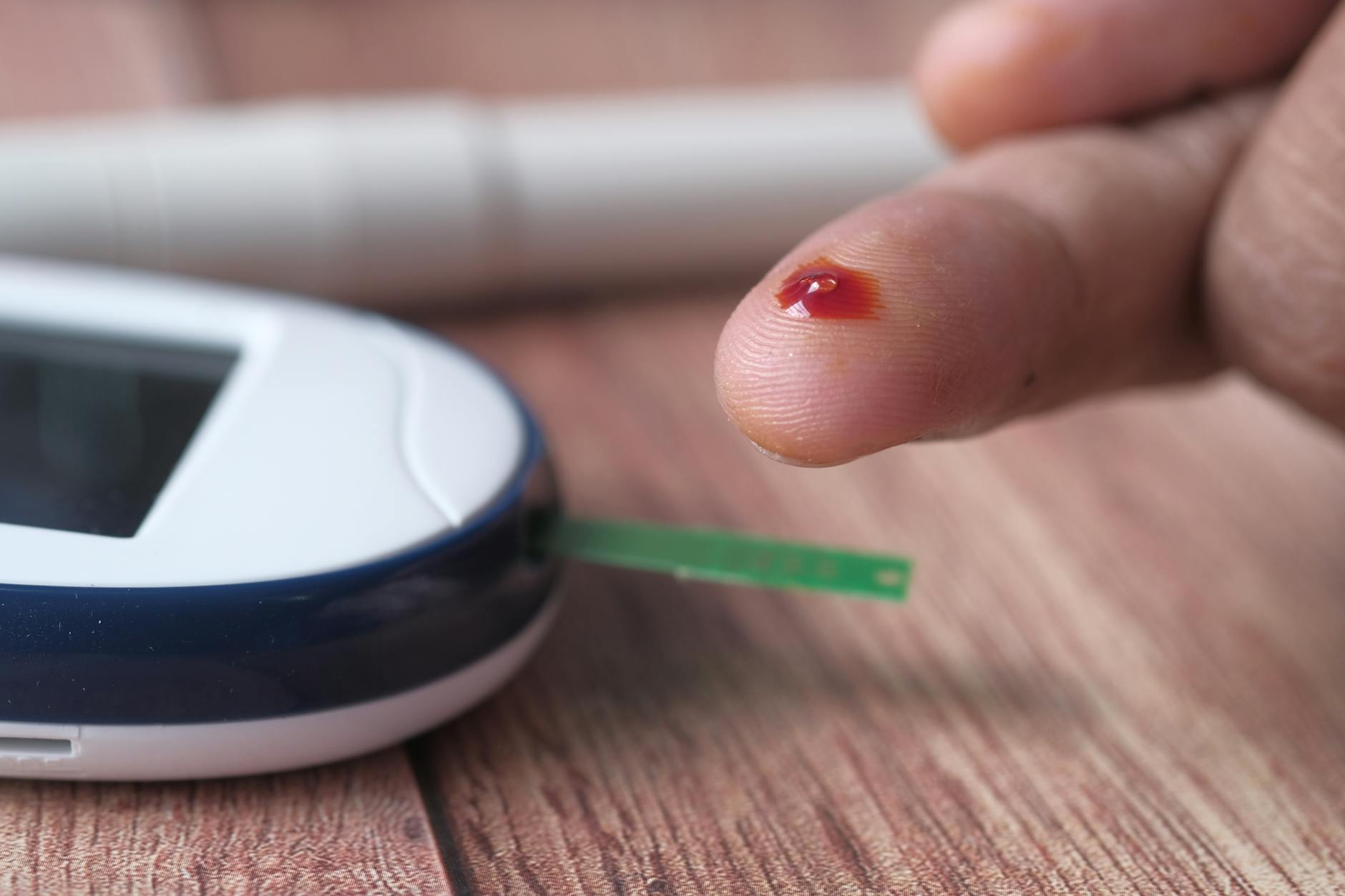 Blood glucose monitor on desk — metabolic health testing