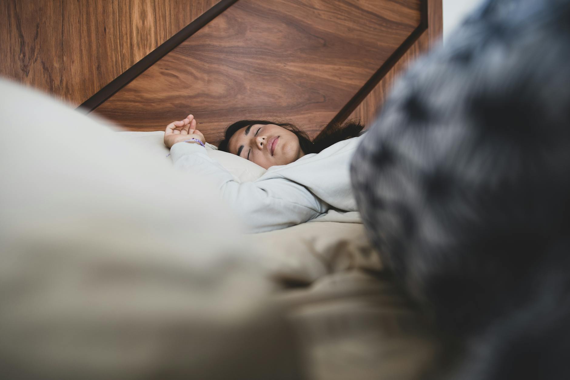 Person sleeping deeply in dark bedroom — growth hormone recovery