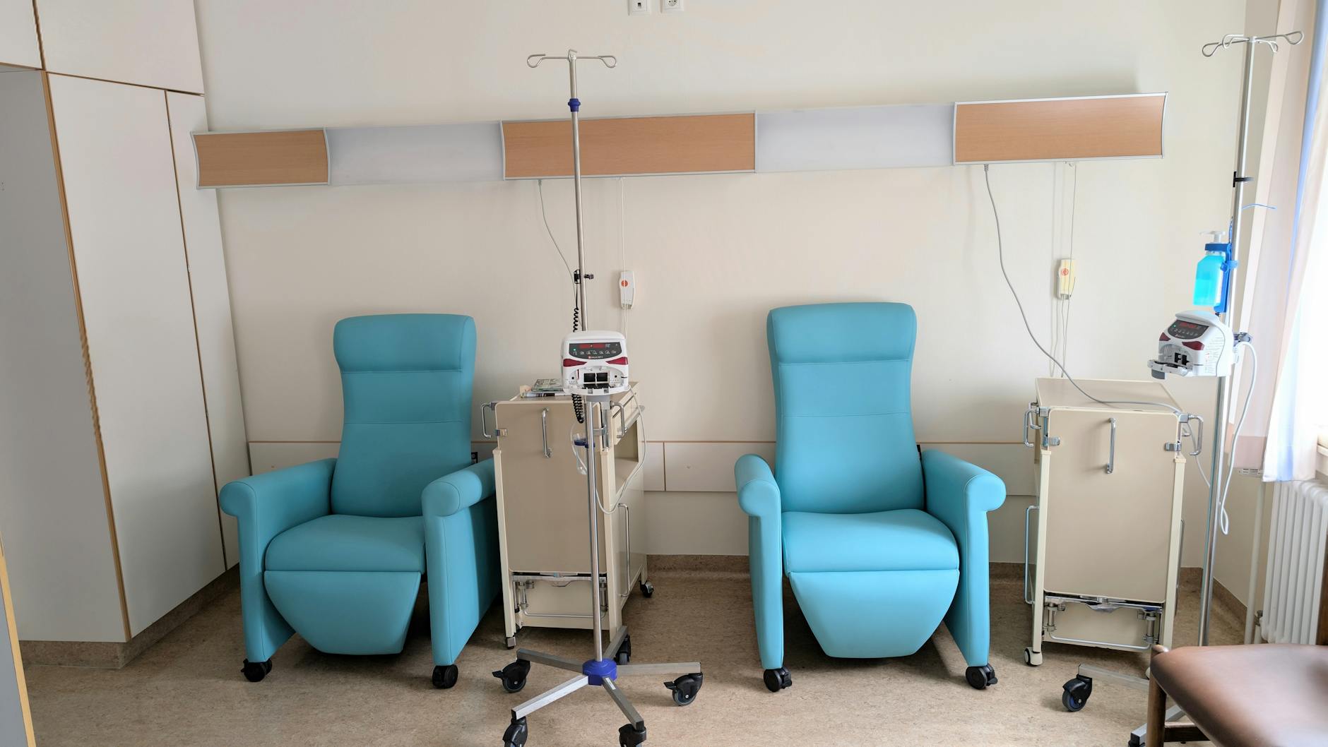 An infusion-clinic treatment room with two reclining chairs, IV poles, and drip pumps — the setting where commercial NAD+ infusions are administered