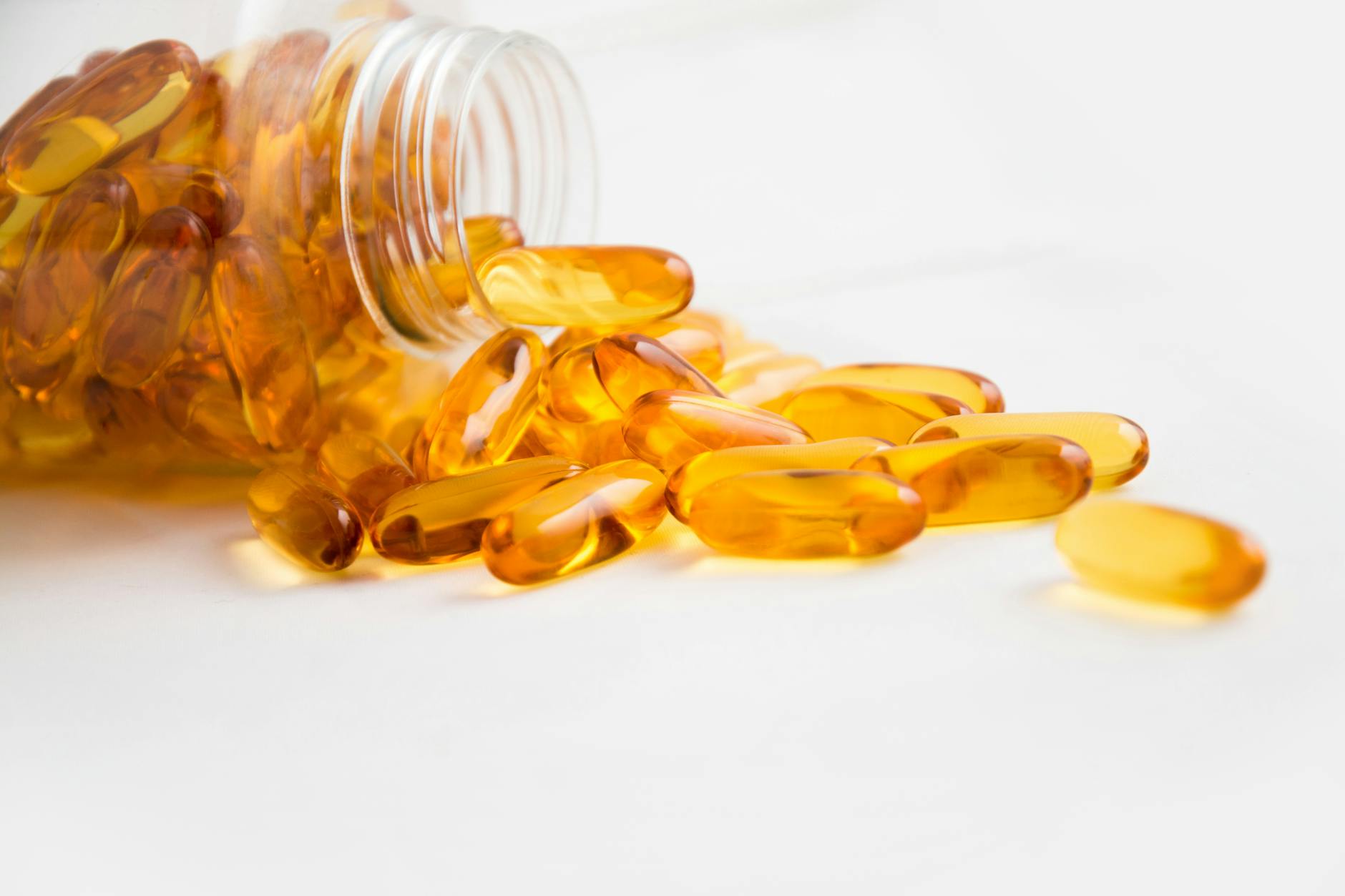 Fish oil softgel capsules on a clinical lab surface, representing omega-3 EPA and DHA supplementation in chronic kidney disease research