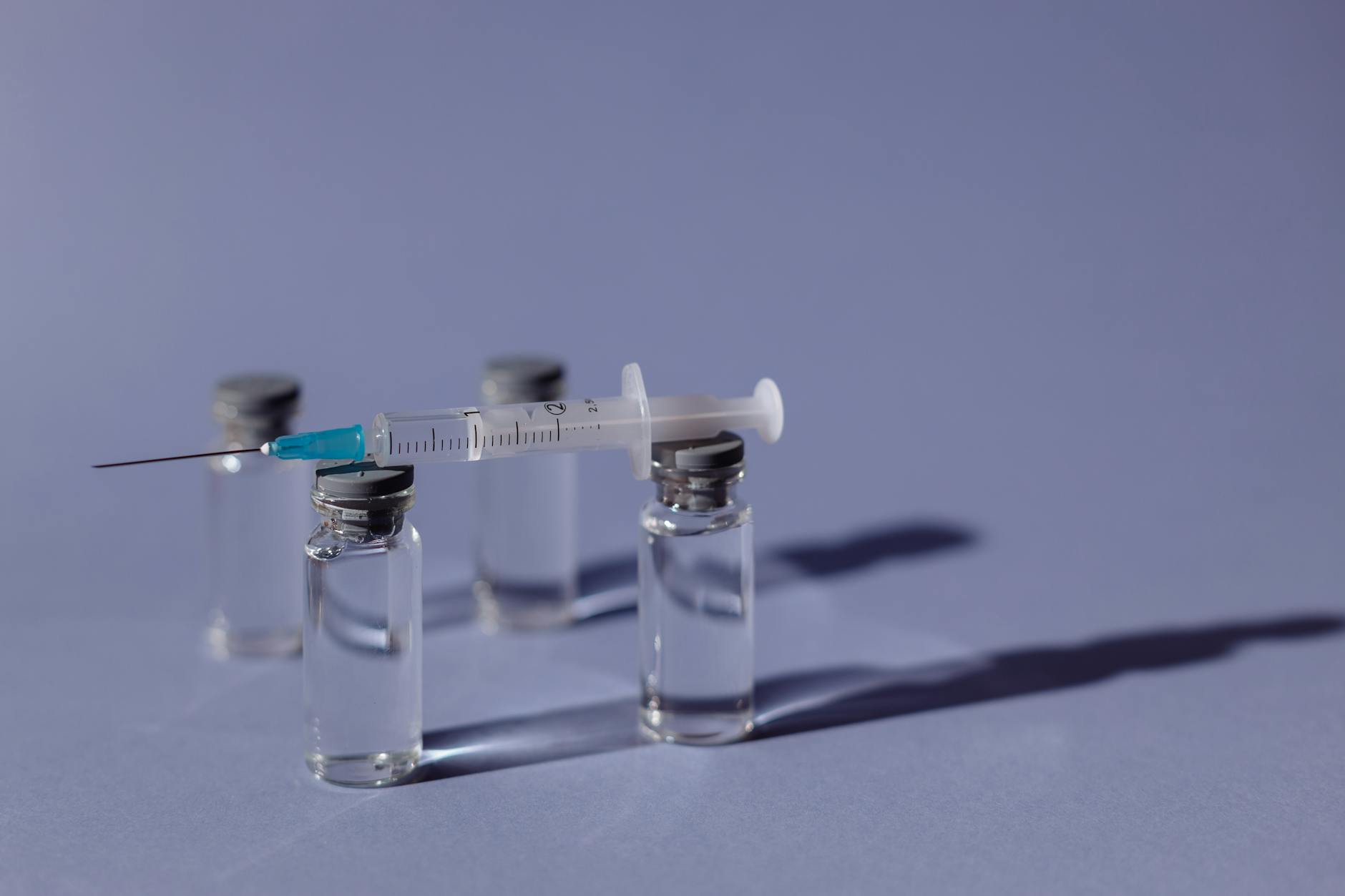 Medical vial and syringe close-up — peptide therapy injection